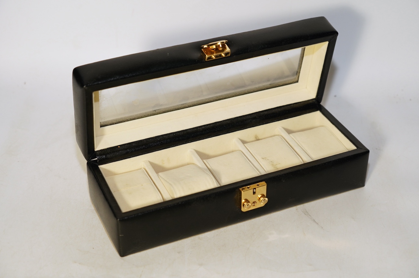 A Geoffrey Parker red leather backgammon set and a black leatherette wrist watch case